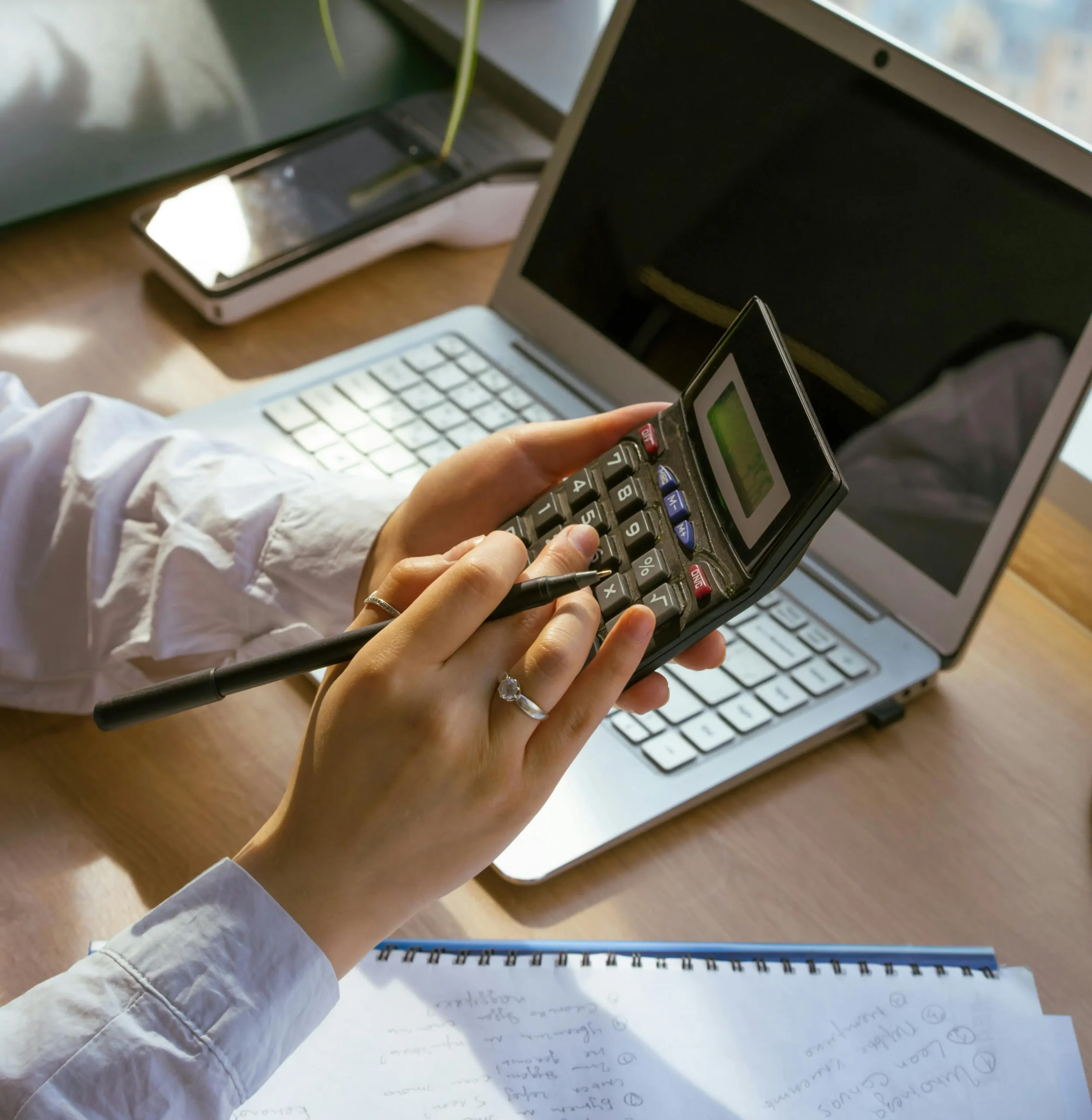 a photo of a man holding a calculator for payroll